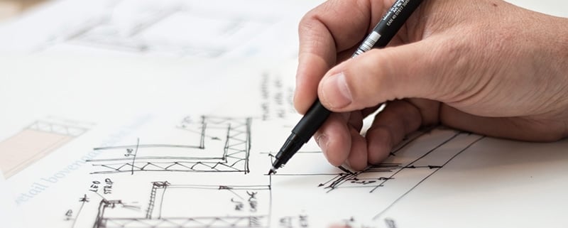 An Architect Drawing a Floor Layout of Real Estate