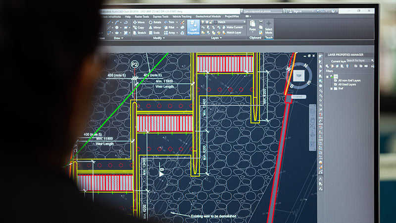 A Person Making Corrections to CAD Drafting